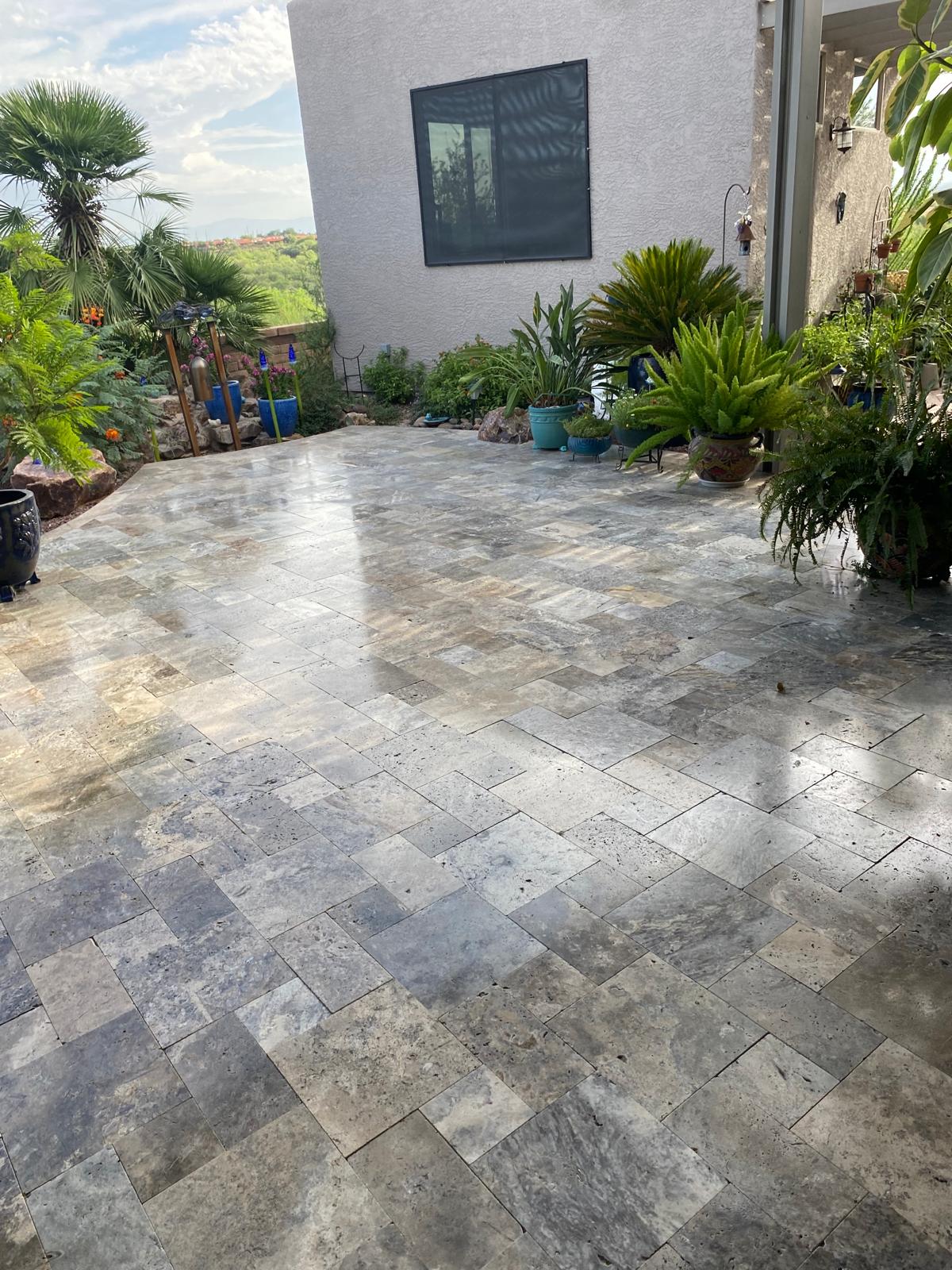 Sealed travertine courtyard patio with potted plants at an Arizona home