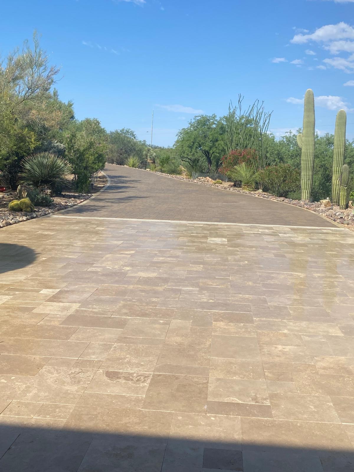 Sealed paver driveway with desert landscaping and saguaro cacti in Arizona